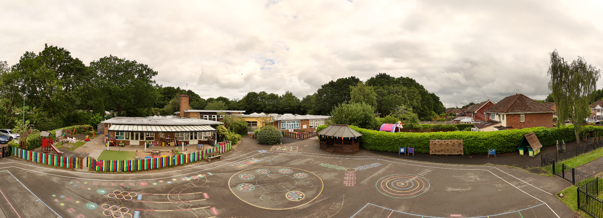 Wide low-aerial panorama of a nursery playground, gazebo and buildings